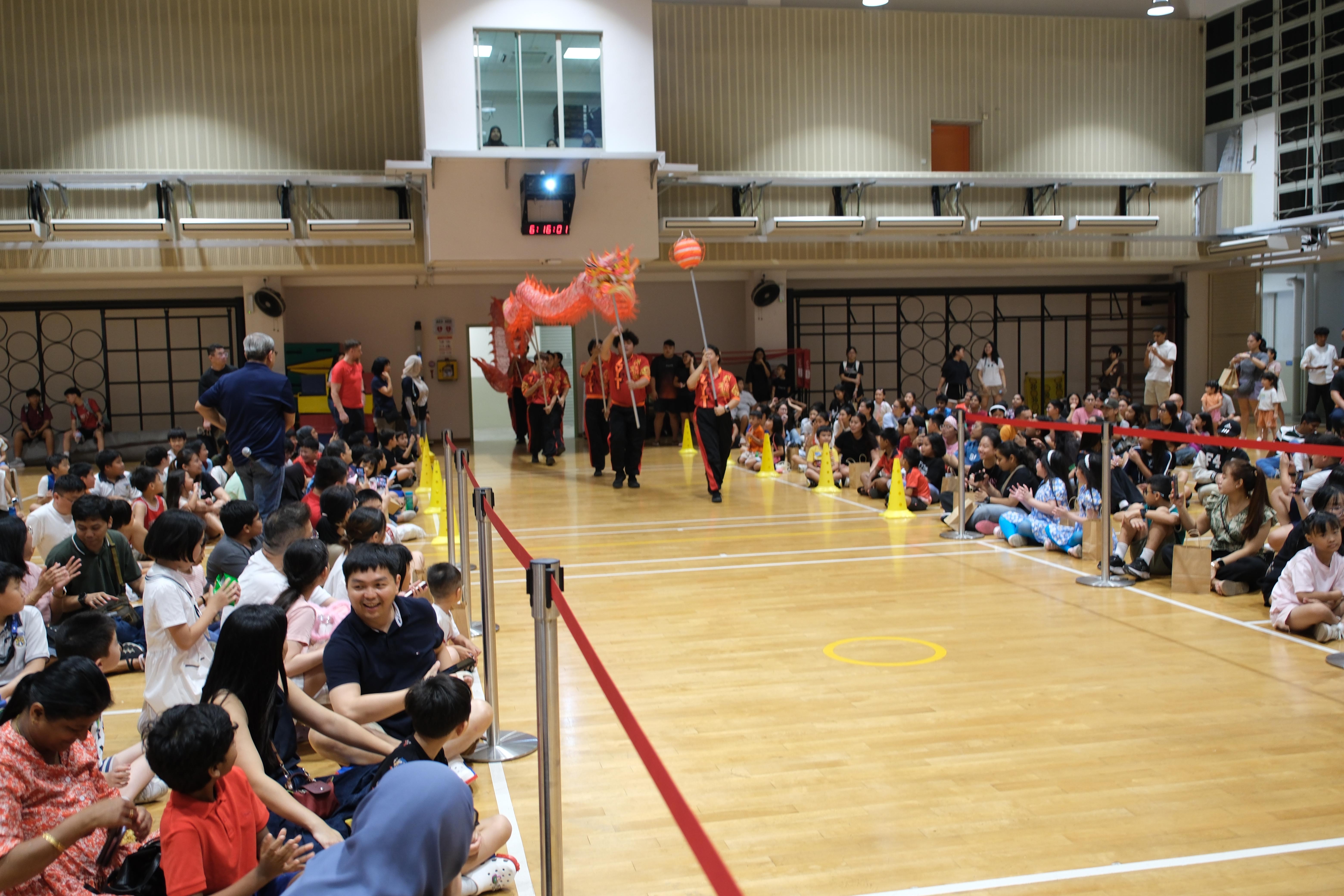 Here comes the dragon! The energetic dragon dance made a grand entrance, drawing excited cheers from the crowd.